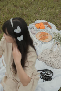 High angle view of woman sitting on grass