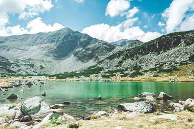 Scenic view of lake and mountains against sky