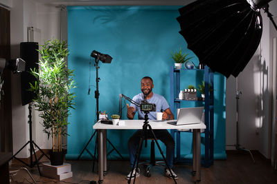 Midsection of woman using laptop on table