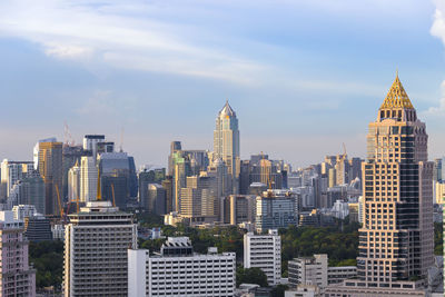 View of skyscrapers against cloudy sky