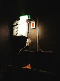 Close-up of illuminated electric lamp against black background