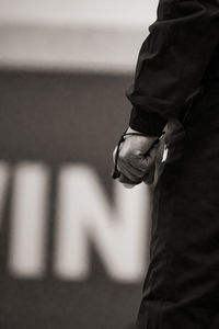 Close-up of a basketball referee's wrist, holding his whistle