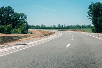 New asphalt road with roadside construction site in the forest. countryside asphalt road 