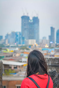 Rear view of woman looking at city