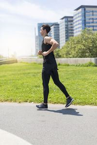 Confident young man exercising during sunny day