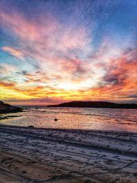 Scenic view of beach against sky during sunset