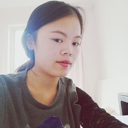 Portrait of beautiful young woman sitting at home