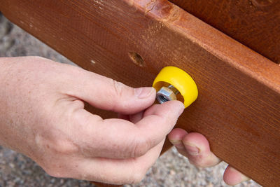 Cropped hand of person holding thermometer