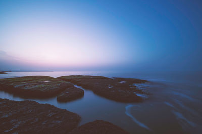 Scenic view of sea against clear sky during sunset