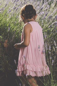 Side view of girl picking lavender at farm