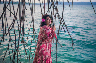 Portrait of woman standing in sea