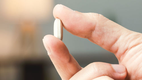 Close up of hand holding medicine pills