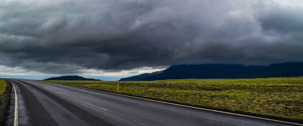 Road by landscape against sky