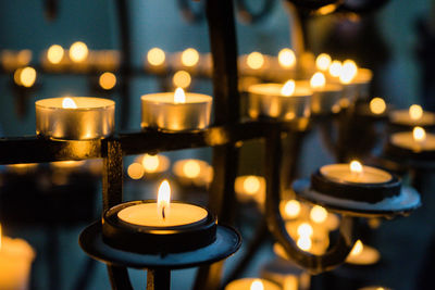 Close-up of illuminated candles in temple