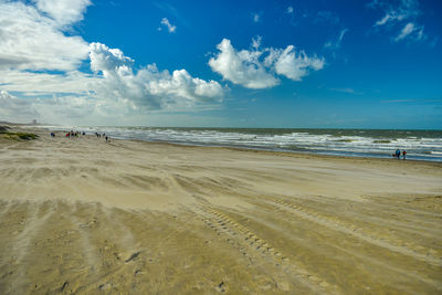 Scenic view of beach against blue sky