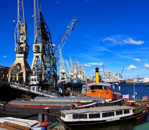 Ship moored at harbor against sky