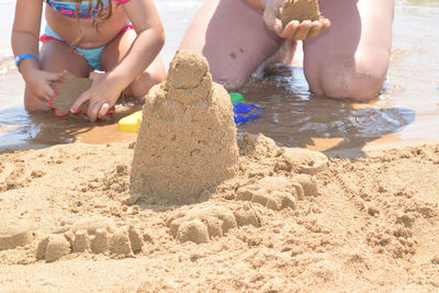 Low angle view of children playing on beach