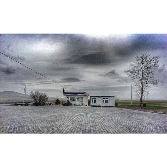 sky, built structure, architecture, cloud - sky, building exterior, auto post production filter, transfer print, cloudy, tree, the way forward, house, overcast, bare tree, cloud, day, no people, weather, outdoors, empty, road