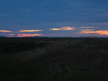 Silhouette of landscape against sky at dusk