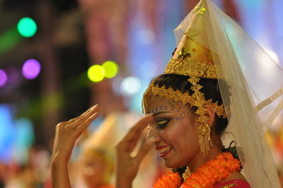 Smiling artist performing traditional dance during carnival