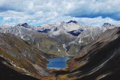 Scenic view of mountains against cloudy sky