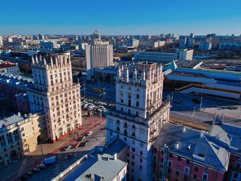 High angle view of buildings against clear blue sky