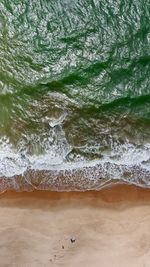 High angle view of surf on beach