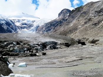 Stream flowing through rocks, view of a glacier