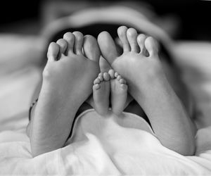 Low section of woman lying on bed