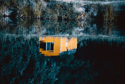Reflection of house on lake