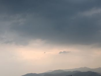 Low angle view of silhouette mountain against sky at sunset