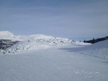 Scenic view of snow covered mountains against sky