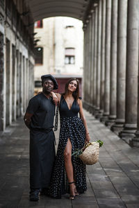 Full length of a smiling young woman outdoors