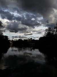 Scenic view of lake in forest against sky