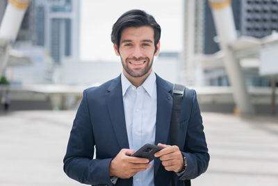 Portrait of businessman using mobile phone