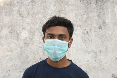 Portrait of young man against wall