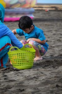 Children playing on sand at beach