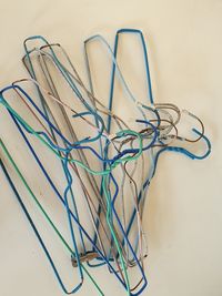 High angle view of multi colored coathangers on table