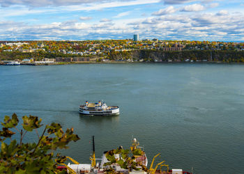 High angle view of sea and cityscape against sky