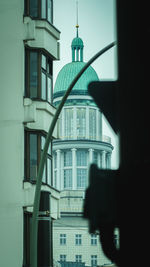 Building against sky seen through glass window