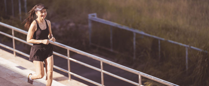 Woman standing on footbridge