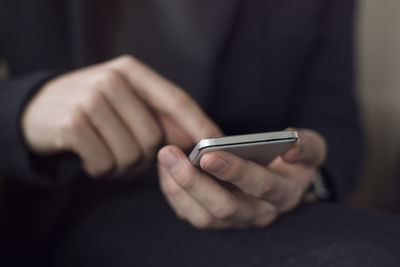 Close-up of man using mobile phone