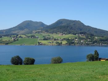 Scenic view of landscape and mountains against clear sky