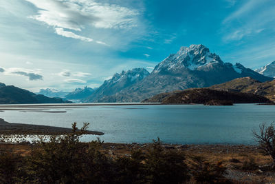 Scenic view of lake and mountains against sky