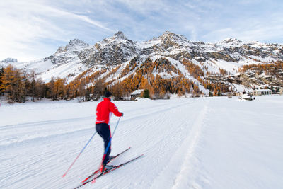 Full length of man skiing on snowcapped mountain during winter