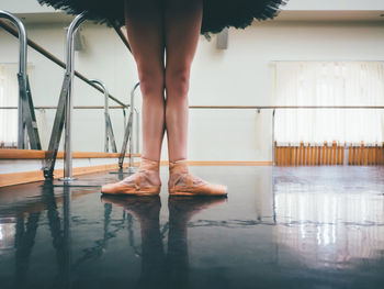 Low section of ballet dancer standing on floor