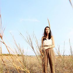 Portrait of woman standing on field