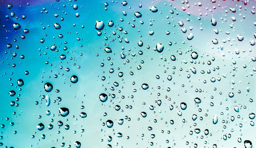 Full frame shot of wet glass window during rainy season