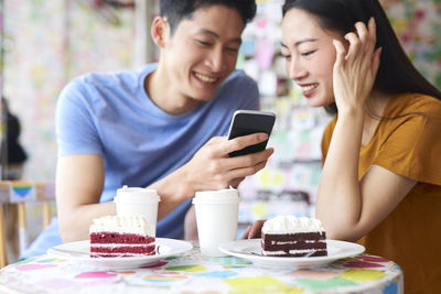 Woman holding ice cream on table