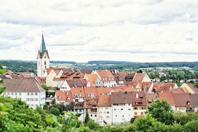 Town by buildings in city against sky